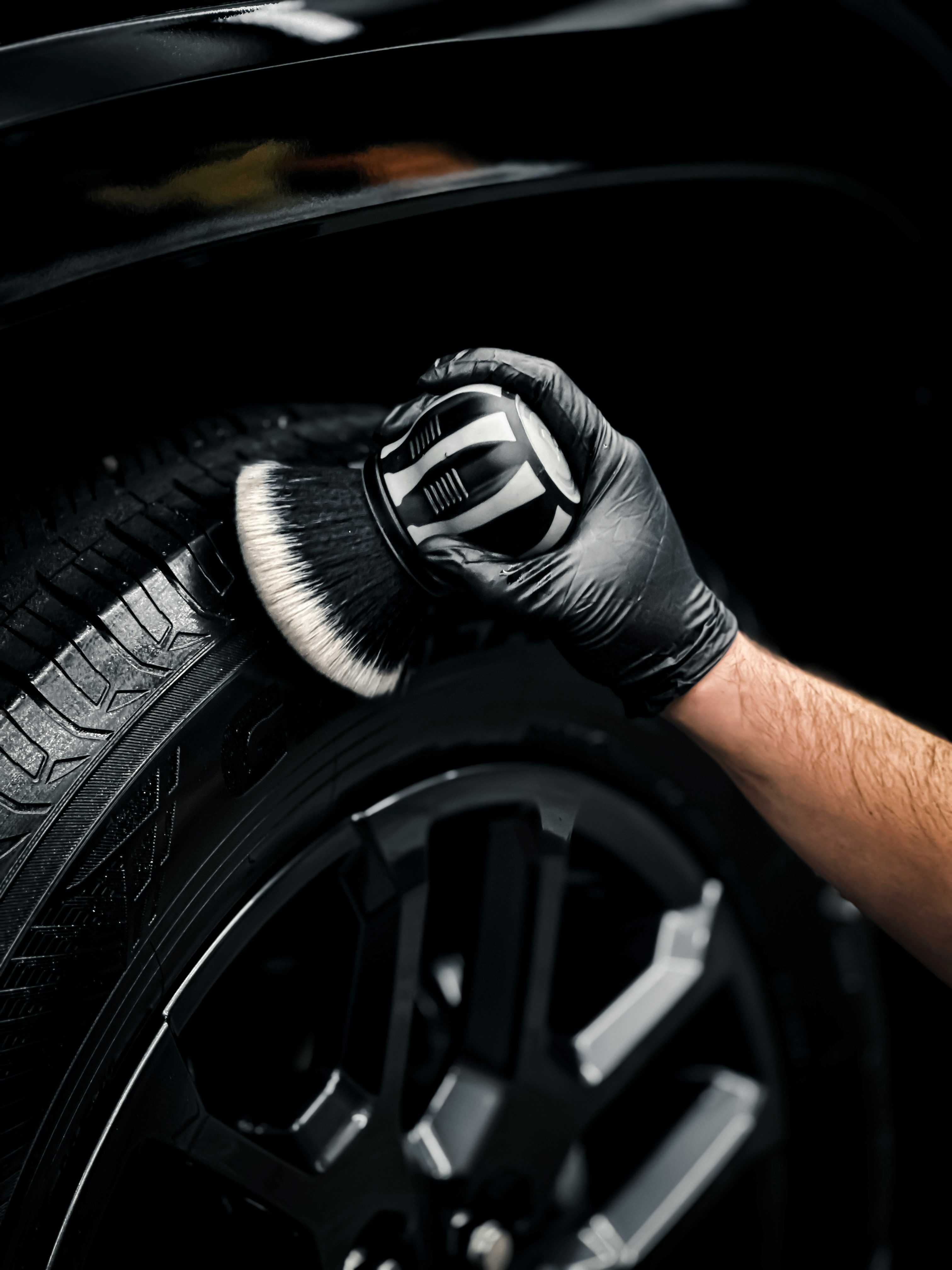 Hand brush of a man claening a wheel